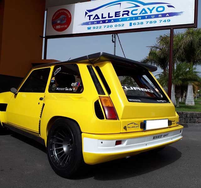 Taller Cayo vehículo reparado amarillo
